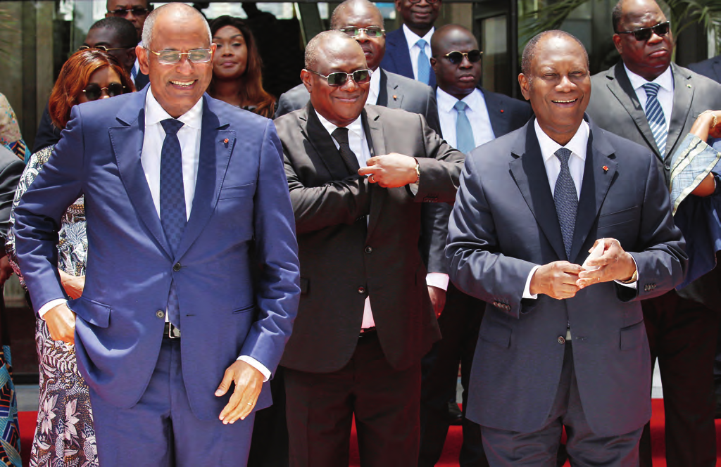 President Alassane Ouattara with Prime Minister Patrick Achi and Defence Minister Téné Birahima Ouattara at the first cabinet meeting of the new government on 7 April. LUC GNAGO/REUTERS