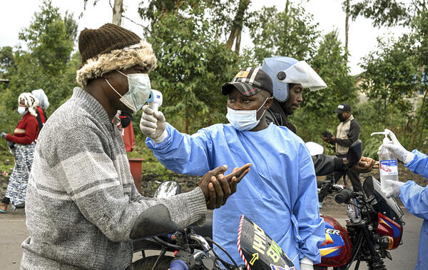 Des praticiens de santé déployés au camp de Kanyaruchinya, en RDC, contrôlent la température des motocyclistes et leur fournissent du gel hydroalcoolique, le 21 mai 2026. ARLETTE BASHIZI/THE NEW YORK TIMES-REDUX-REA